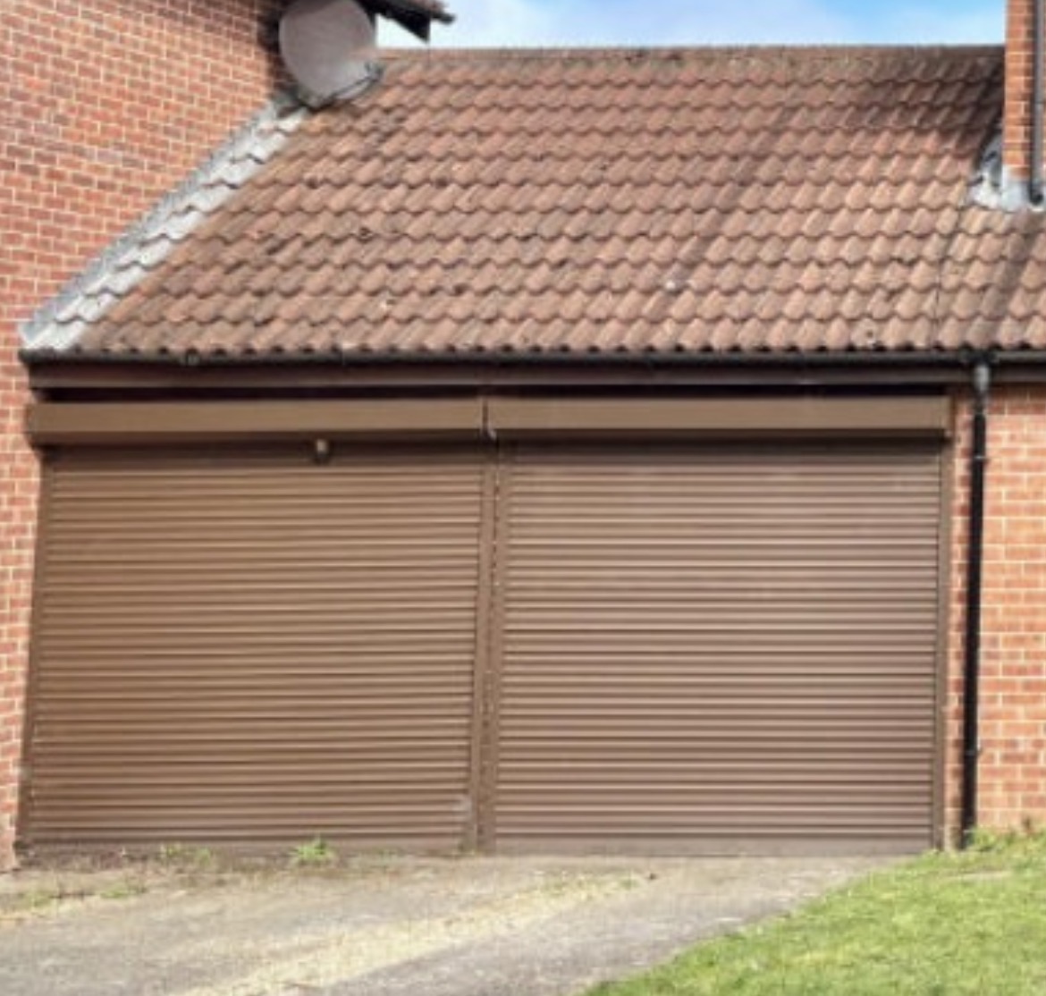Pair of brown roller garage doors on a double garage