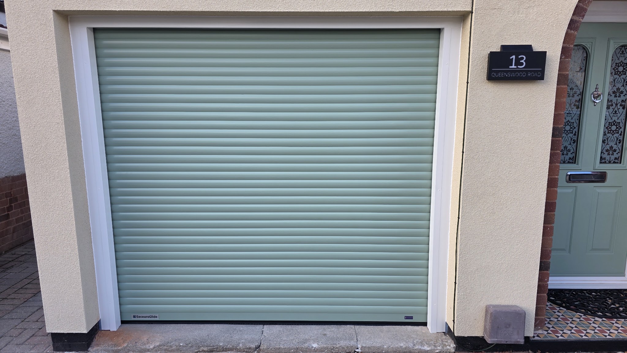Sage green roller garage door close up