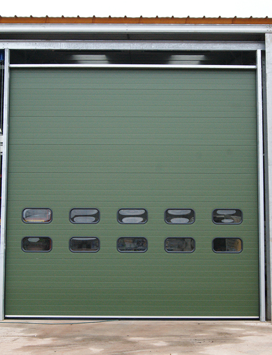 Green insulated sectional industrial door with vision panels in Bridgwater