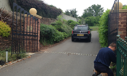 Black metal automatic driveway gates with the A-Door Solutions van behind