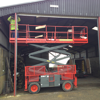 Scissor lift in place for an industrial door installation