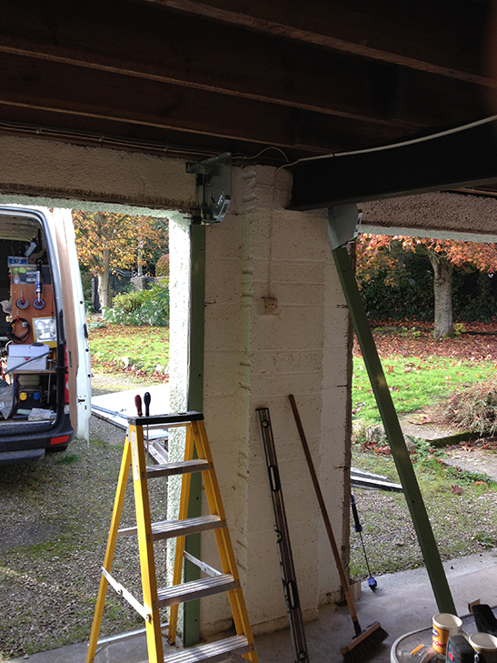 A-Door Solutions engineer in hi-vis working on a garage door in Taunton